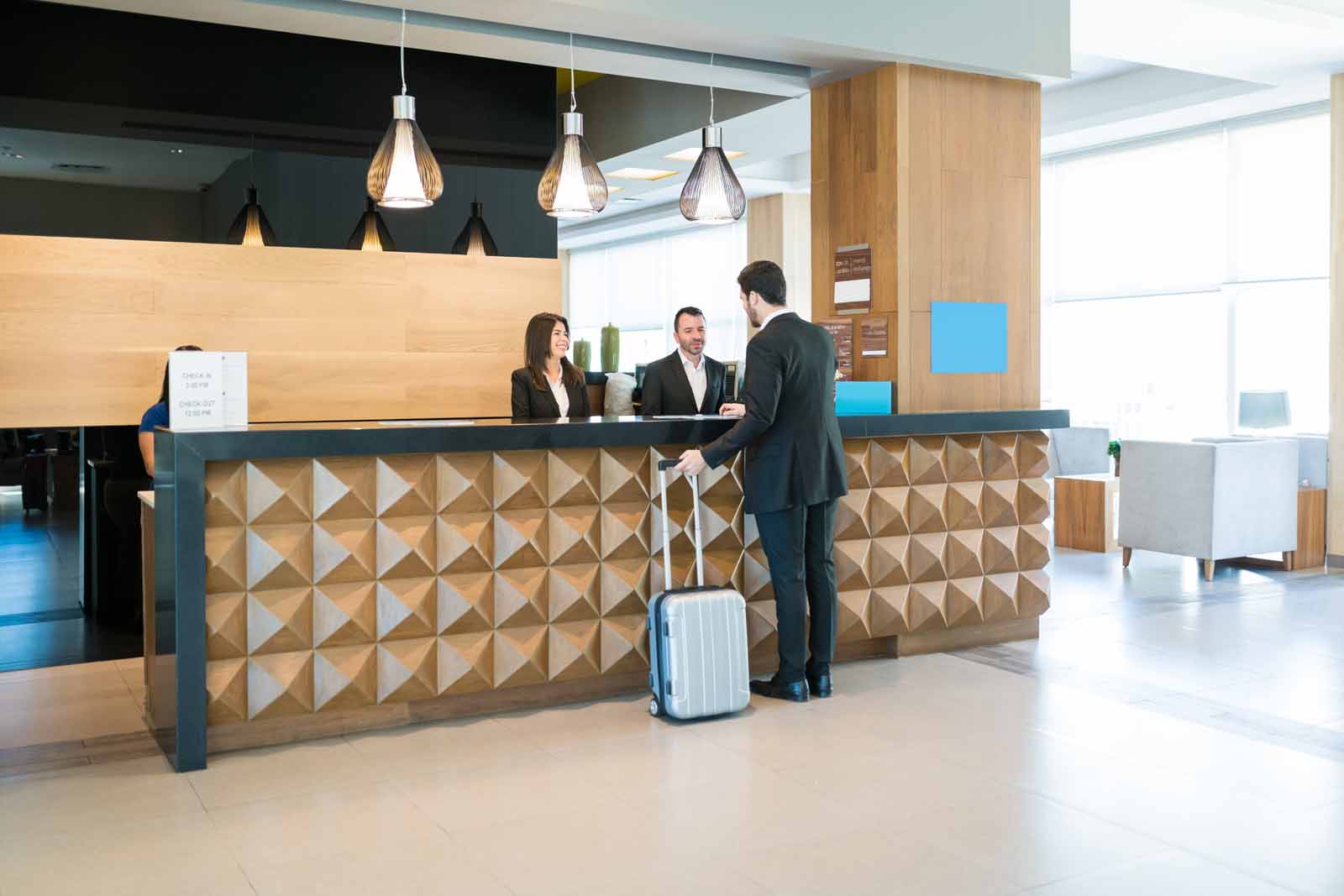 Modern shopping mall interior. Busy sale time Happy Hotel Clerks Are Welcoming Professional At Counter